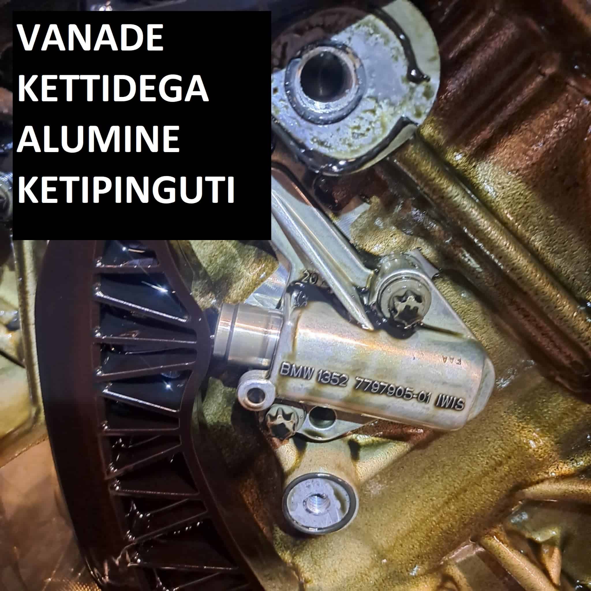 BMW mootori alumiiniumist ketipinguti vanade kettidega – kulunud ajamikomponentide lähivaade.